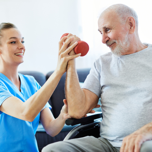 young woman assisting older man with a dumbbell exercise