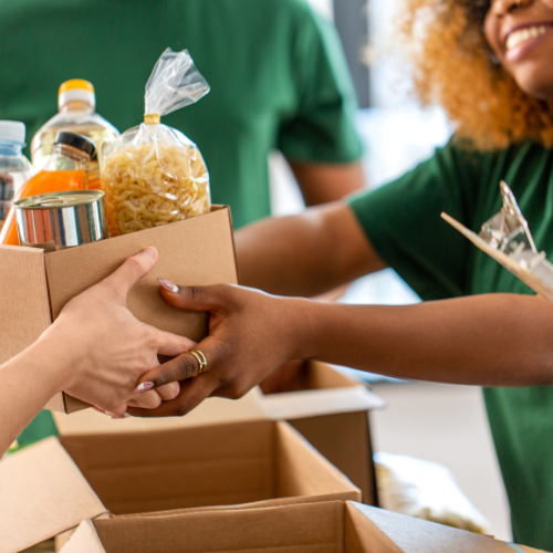 volunteer distributing boxed goods